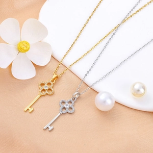 Detail of clover key necklaces in gold and silver with pave setting on display
