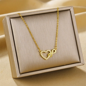 Gold infinity heart necklace with micro-pave zircons displayed on silk in a gift box