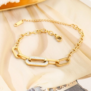 Gold stainless steel anklet featuring triple O-ring charms with pavé diamond accents