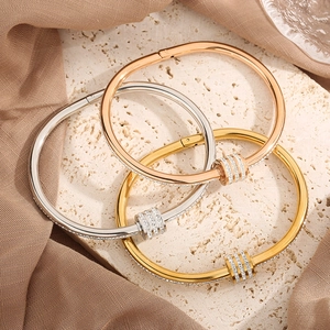 Polished titanium steel bangles in rose gold, silver, and gold with pave diamond accents