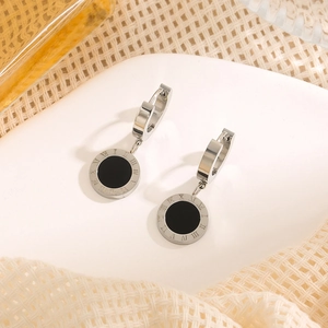 Minimalist silver Roman numeral hoop earrings with black inlay on ceramic plate