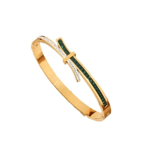 Asymmetric gold bangle with emerald square stones and cubic zirconia inlay