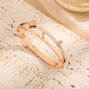 Rose gold butterfly bangle with double row pavé diamonds and frosted butterfly accents