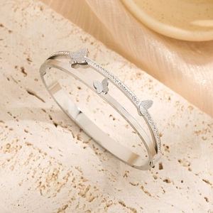 Silver double-layer butterfly bracelet with rhinestones and matte charms on stone tray