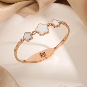 Rose gold clover bangle with white mother-of-pearl flowers and zircon accents