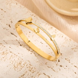 Golden double-layer butterfly bangle with sparkling pavé rhinestones and matte finish