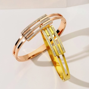 Sparkling titanium steel bangles in rose gold and gold with micro-pave crystals