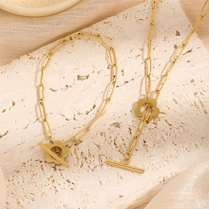 Gold paperclip chain necklace and bracelet set with elegant floral toggle clasp