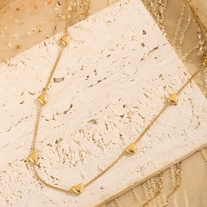 Elegant gold heart charm necklace with multiple tiny heart pendants on thin link chain