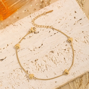 Elegant gold-plated heart bracelet set featuring four charms on a stainless steel chain