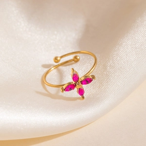 Bague ouverte dorée élégante avec un trèfle à quatre feuilles et zircons magenta