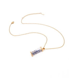 Close-up of glass tube pendant with natural stones and S.Steel logo on gold chain
