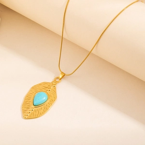 Bohemian gold leaf necklace with turquoise teardrop stone in a vintage finish
