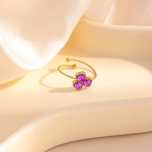 Bague dorée réglable avec trois zircons coeurs violets et un design de corde torsadée