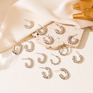 Minimalist silver stainless steel hoop earrings in various geometric styles and textures