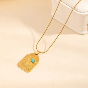 Golden stainless steel necklace with snake relief pendant and blue gemstone