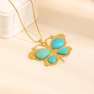 Golden butterfly necklace with turquoise stones and a slender snake chain design