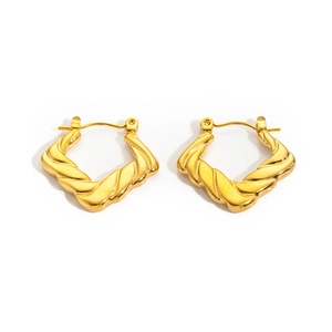 Detail of gold geometric hoop earrings with vintage twisted rope texture and metal finish
