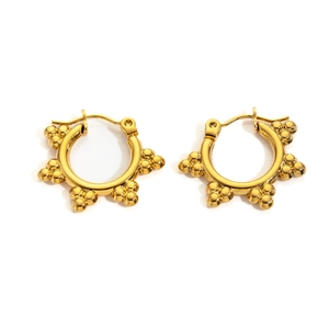 Detailed close-up of 18K gold-plated star hoop earrings with delicate beaded metal details