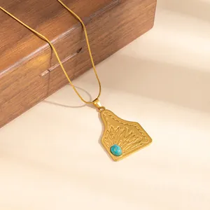 Golden stainless steel necklace with engraved floral pendant and turquoise stone