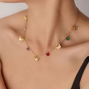 Close-up of gold stainless steel necklace with butterfly charms and colorful crystals