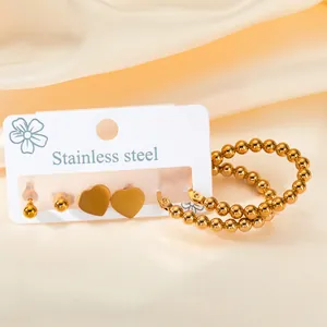 Set of 3 gold stainless steel earrings featuring bead studs, hearts, and hoop styles