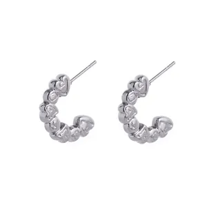 Silver stainless steel C-shaped hoop earrings featuring a stylish 3D heart pattern