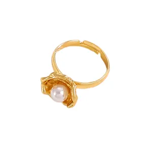Detailed view of an adjustable golden ring featuring an irregular petal-wrapped white pearl