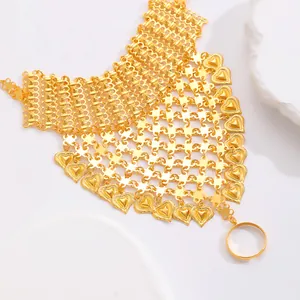 Luxurious gold slave bracelet featuring mesh hand chain and heart charms on white stones