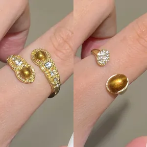 Detail of adjustable gold-plated ring set with tiger eye stone and sparkling crystals