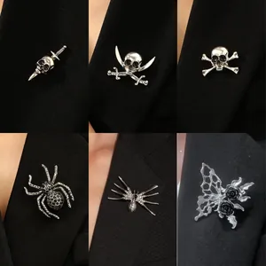 Halloween spider and skull brooches set with crystal rhinestones on a black suit jacket
