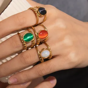 Detailed macro view of four asymmetric titanium steel rings with colored cat-eye stones