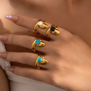 Set of four gold stainless steel open rings featuring white, black, blue and turquoise stones