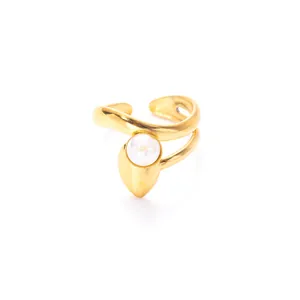 Macro shot of gold double-band open ring featuring a round white moonstone cabochon