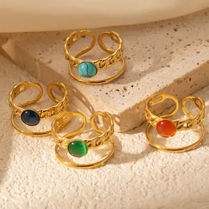 Detail of four adjustable 18k gold plated titanium rings with colorful round gemstones