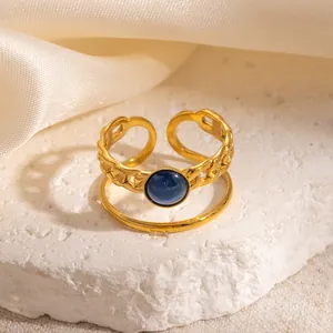 Detailed shot of gold plated adjustable ring with blue cat eye stone and chain design