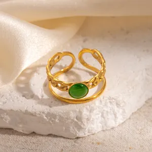 Detail of adjustable double-layer gold ring with chain texture and green cat-eye stone