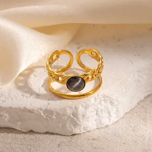 Detail of adjustable 18k gold plated double-layer ring with grey cat eye stone