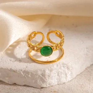 Detailed view of an 18k gold plated double-layer adjustable ring with green stone inlay