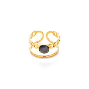 Close-up of gold plated double layer ring with chain design and cat eye stone detail