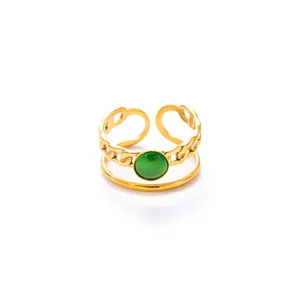 Detail of adjustable gold ring featuring a dual-layer chain band and green cat eye stone