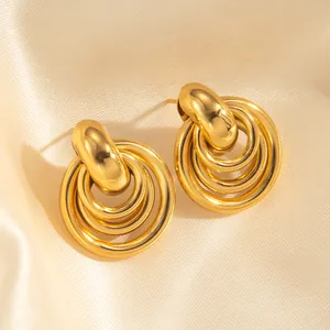 Chic 18k gold plated triple layer circular drop earrings on luxury champagne silk backdrop