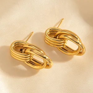 Detail of 18k gold plated chunky triple-layered hoop earrings on champagne silk background