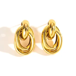 Macro view of interwoven 18k gold plated triple ring earrings in a vintage knot design