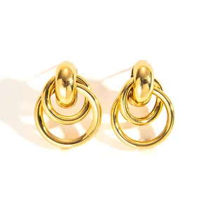 Detailed close-up of 18k gold-plated double hoop earrings with a high-polished finish