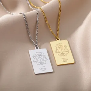 Collares con colgante del signo Libra en oro y plata sobre seda color champán