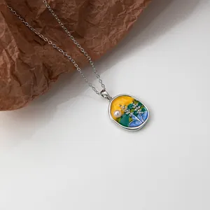 Artistic enamel floral pendant with pearl detail on a textured brown background