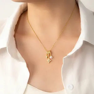 Detail view of gold O-chain necklace with pearl, star charms, and octopus star pendant