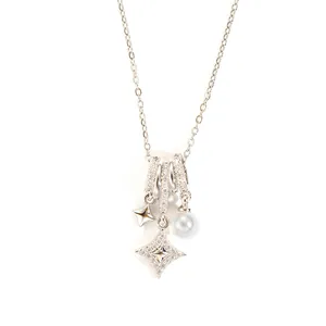 Detail of star pendants with pearl and pavé crystals on a silver chain necklace