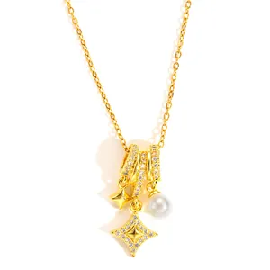 Detail of gold necklace featuring star pendants with zircon inlay and a round white pearl